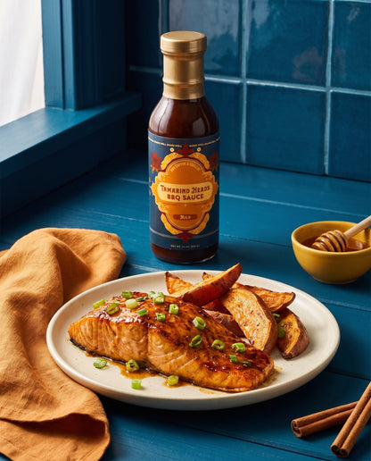 Tamarind Heads Spiced Honey Mild BBQ sauce in use at the table